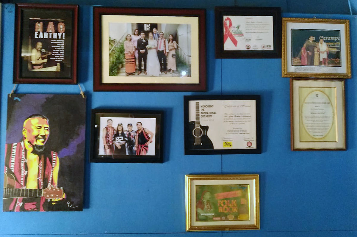 The wall at his home is adorned with photographs of himself